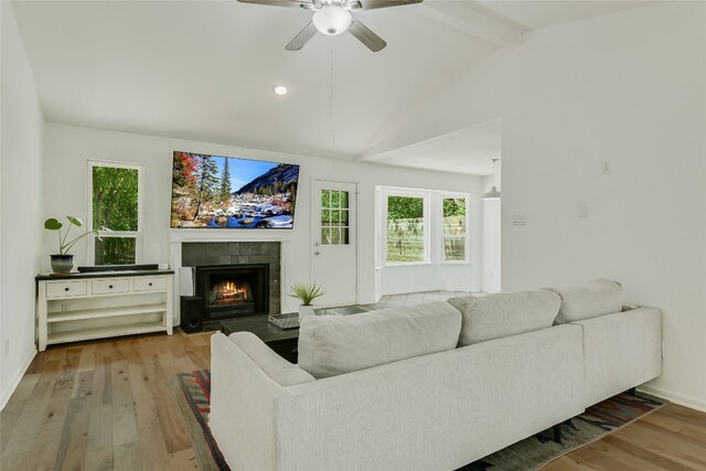 4015 Alexandria Dr, Austin, TX 78749 - living room featuring wood finished floors, a tiled fireplace, a ceiling fan, plenty of natural light, and recessed lighting
