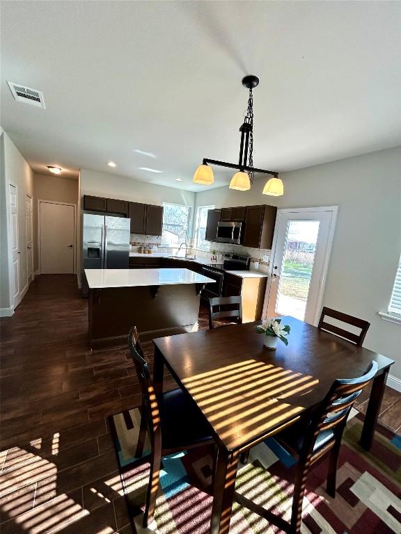 dining room with visible vents, recessed lighting, baseboards, and dark wood-type flooring