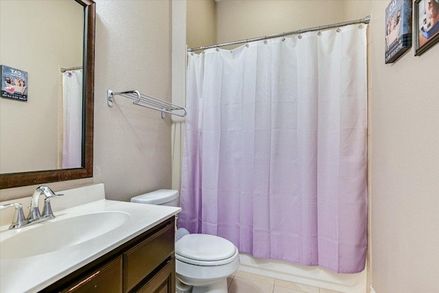 bathroom featuring toilet, vanity, and tile patterned flooring