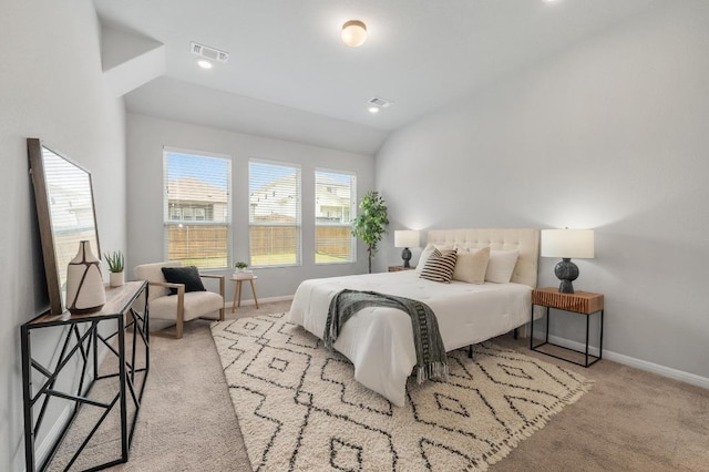 bedroom featuring baseboards, visible vents, vaulted ceiling, and carpet