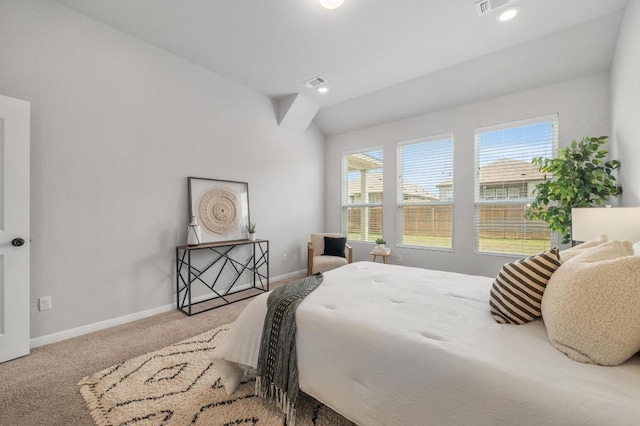 bedroom featuring carpet floors, baseboards, visible vents, and vaulted ceiling