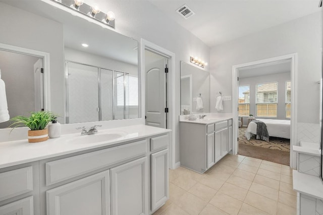 full bathroom with connected bathroom, vanity, tile patterned floors, visible vents, and a stall shower