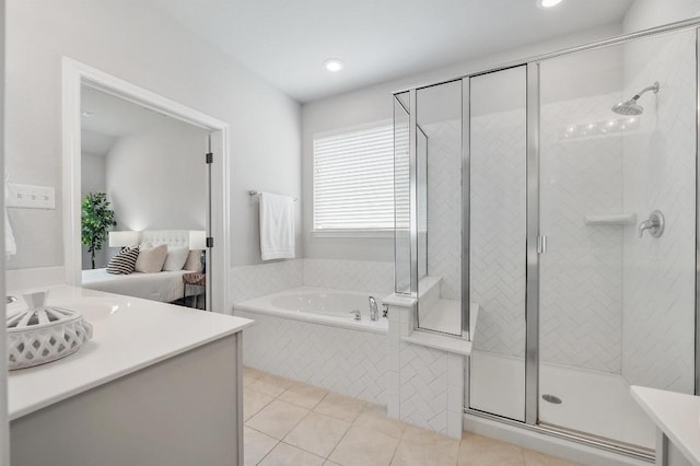 full bathroom featuring a bath, tile patterned flooring, a shower stall, vanity, and ensuite bathroom