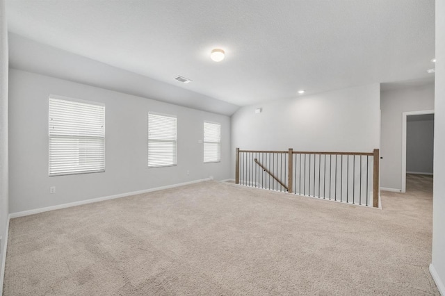 carpeted empty room with baseboards and visible vents