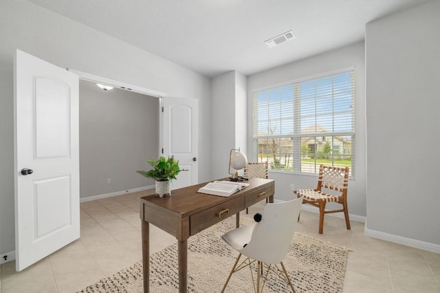 office space featuring light tile patterned floors, baseboards, and visible vents