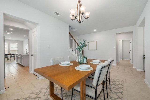 dining space featuring visible vents, stairs, baseboards, a chandelier, and light tile patterned floors