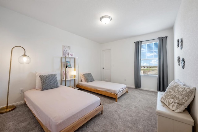 bedroom featuring carpet floors and baseboards