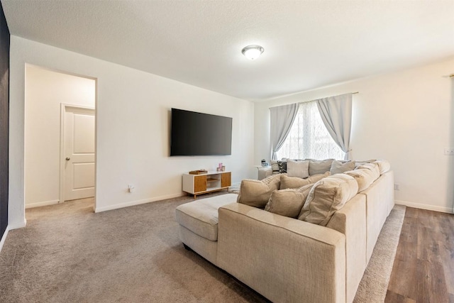 carpeted living area with baseboards