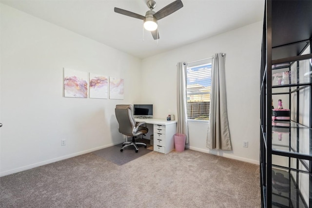 office space with carpet floors, baseboards, and a ceiling fan