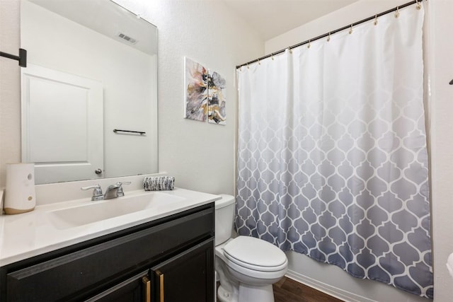 full bath featuring visible vents, wood finished floors, vanity, toilet, and a shower with shower curtain