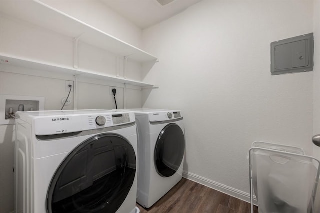 washroom featuring laundry area, washer and dryer, baseboards, dark wood-type flooring, and electric panel