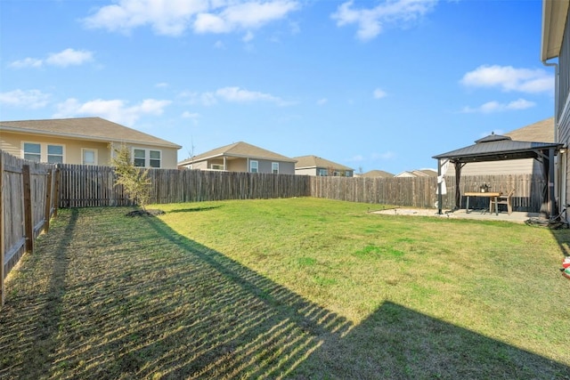 view of yard with a fenced backyard, a gazebo, and a patio area