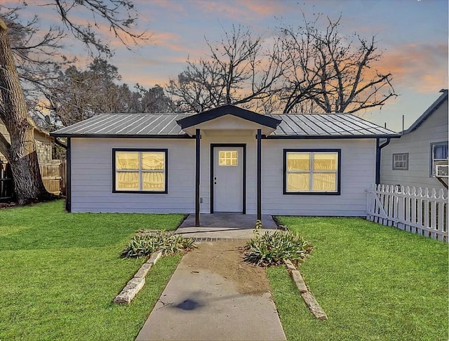 704 Sheffield Ave, Llano, TX 78654 - view of front of property featuring fence, metal roof, a standing seam roof, and a front lawn