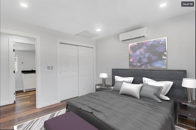 704 Sheffield Ave, Llano, TX 78654 - bedroom featuring a wall mounted air conditioner, a closet, recessed lighting, and wood finished floors