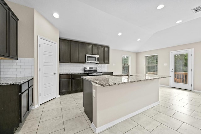 5407 Thunderbird St, Lago Vista, TX 78645 - kitchen with stainless steel appliances, light tile patterned flooring, a sink, and tasteful backsplash