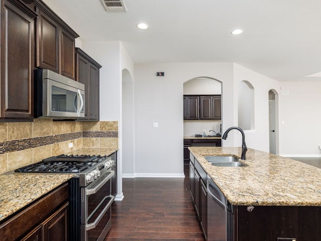 kitchen with visible vents, dark wood-style flooring, baseboards, a sink, and appliances with stainless steel finishes