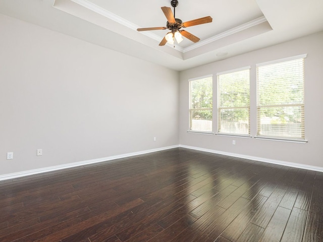 2040 Elaina Loop, Leander, TX 78641 - unfurnished room featuring a tray ceiling, crown molding, dark wood-style flooring, and baseboards