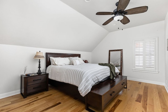 bedroom with baseboards, ceiling fan, vaulted ceiling, and light wood-type flooring