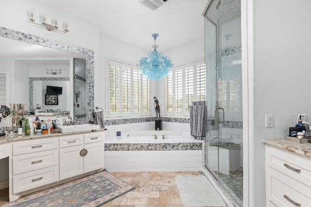 bathroom with vanity, a chandelier, visible vents, a bath, and a stall shower