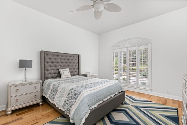 bedroom featuring baseboards, ceiling fan, and wood finished floors