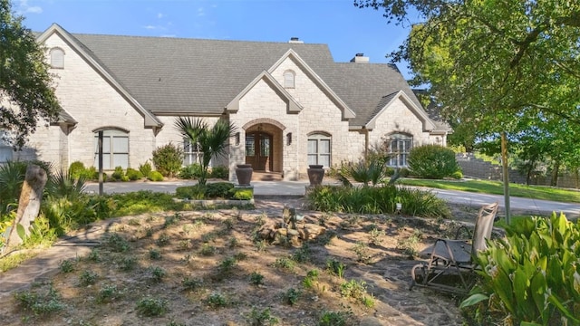 805 Brooks Hollow Rd, Lakeway, TX 78734 - french provincial home featuring stone siding, french doors, and a chimney