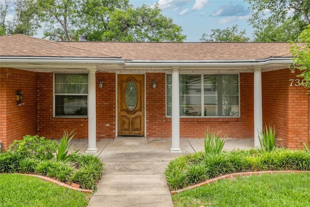 7300 Greenhaven Dr, Austin, TX 78757 - doorway to property with brick siding, covered porch, and a shingled roof