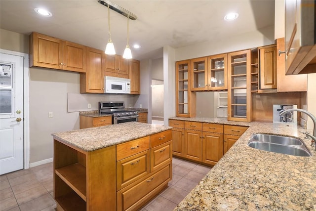7300 Greenhaven Dr, Austin, TX 78757 - kitchen with gas stove, open shelves, white microwave, a sink, and recessed lighting