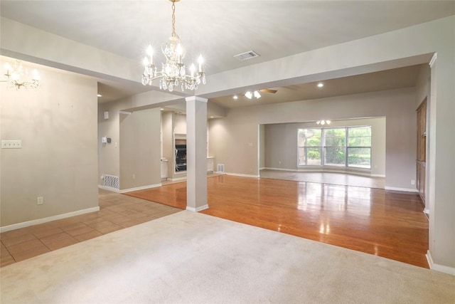 7300 Greenhaven Dr, Austin, TX 78757 - spare room with a chandelier, carpet flooring, baseboards, wood finished floors, and recessed lighting