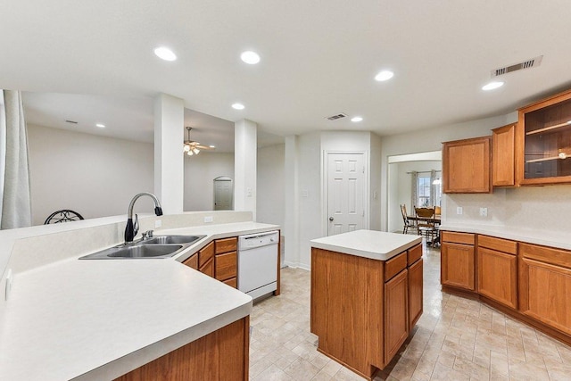 kitchen featuring a sink, a center island, visible vents, and dishwasher
