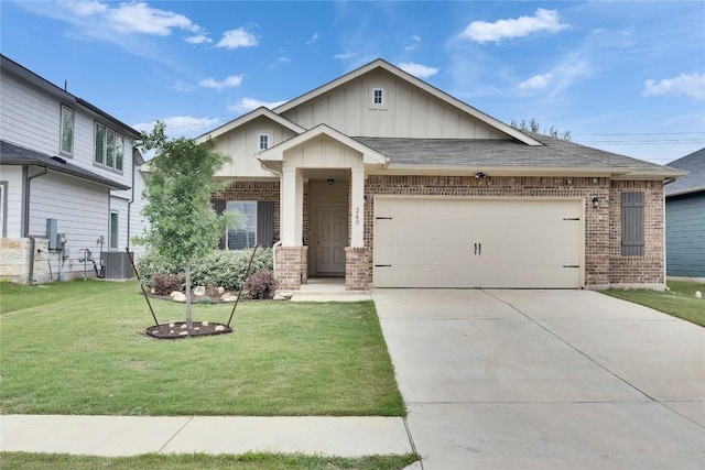 240 Olympic Park Dr, Kyle, TX 78640 - craftsman-style house with board and batten siding, an attached garage, a front lawn, and brick siding