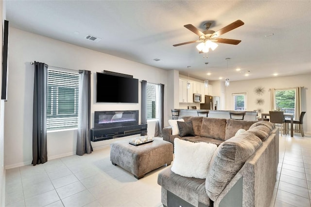 240 Olympic Park Dr, Kyle, TX 78640 - living room with ceiling fan, visible vents, light tile patterned floors, baseboards, and recessed lighting