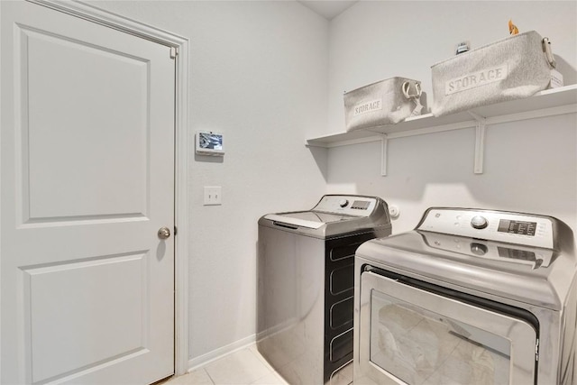 240 Olympic Park Dr, Kyle, TX 78640 - laundry area featuring washer and clothes dryer and light tile patterned floors