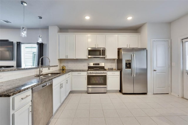 240 Olympic Park Dr, Kyle, TX 78640 - kitchen featuring white cabinets, appliances with stainless steel finishes, a sink, backsplash, and visible vents