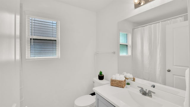 full bathroom featuring vanity, toilet, and curtained shower