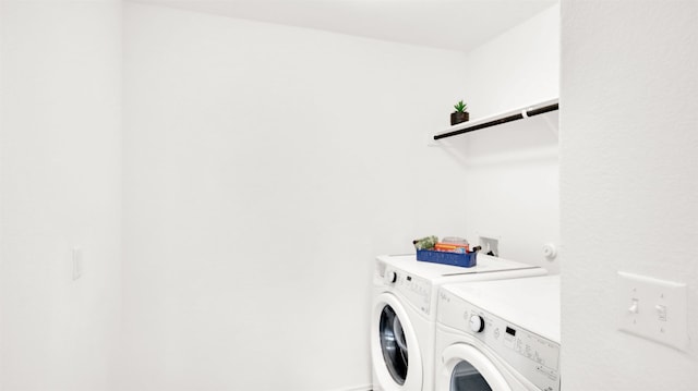 laundry area featuring separate washer and dryer and laundry area