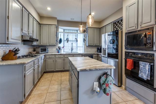 kitchen with a sink, gray cabinets, black appliances, and under cabinet range hood