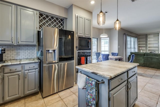 kitchen with open floor plan, tasteful backsplash, light tile patterned floors, black appliances, and gray cabinetry