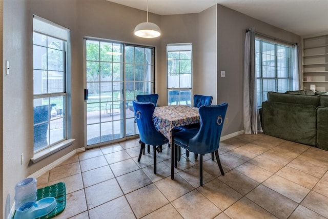 dining room featuring light tile patterned floors and baseboards