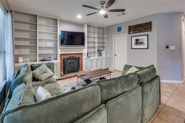 living room with light tile patterned flooring, a ceiling fan, baseboards, and a fireplace