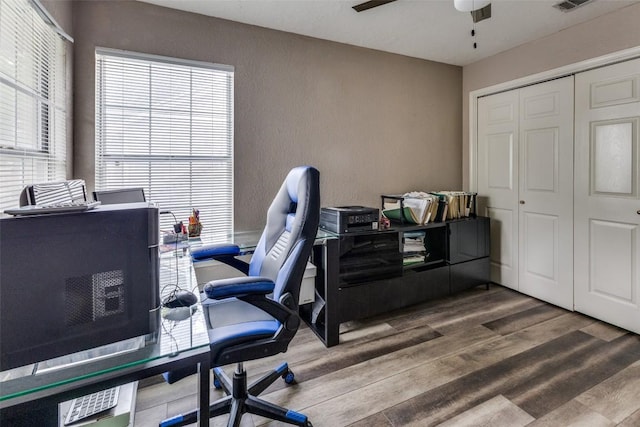 office featuring visible vents, ceiling fan, and wood finished floors