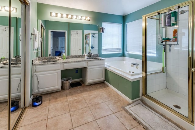 bathroom with vanity, tile patterned floors, a bath, and a stall shower