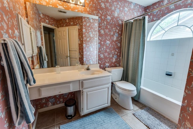 bathroom with tile patterned floors, wallpapered walls, and visible vents