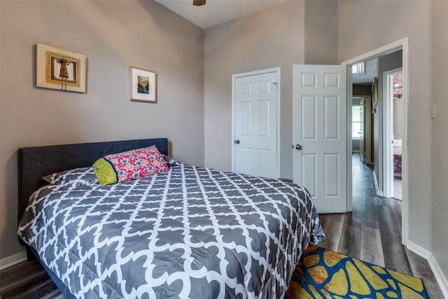 bedroom featuring baseboards, a ceiling fan, and wood finished floors