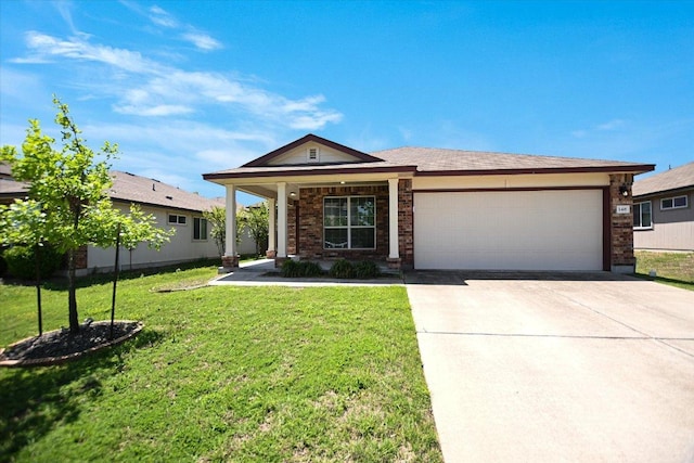 single story home featuring an attached garage, concrete driveway, brick siding, and a front yard