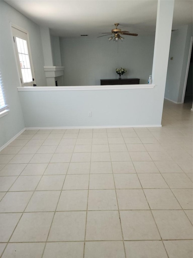 1712 Southwestern Dr, Round Rock, TX 78664 - spare room with a ceiling fan, a fireplace, and light tile patterned flooring