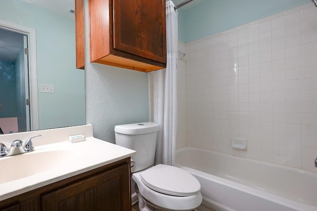 full bath featuring toilet, a textured wall, shower / bath combo, and vanity