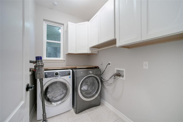 103 Sierra Ridge Dr, San Marcos, TX 78666 - washroom featuring baseboards, washer and clothes dryer, cabinet space, and light tile patterned flooring