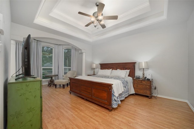 103 Sierra Ridge Dr, San Marcos, TX 78666 - bedroom with crown molding, ceiling fan, arched walkways, light wood-style flooring, and a tray ceiling