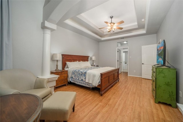 103 Sierra Ridge Dr, San Marcos, TX 78666 - bedroom featuring ceiling fan, light wood finished floors, a raised ceiling, ornate columns, and visible vents