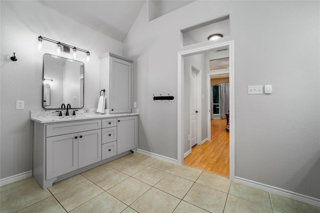 103 Sierra Ridge Dr, San Marcos, TX 78666 - bathroom with vanity, tile patterned floors, and lofted ceiling